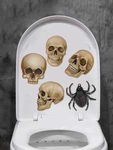 Halloween bathroom stickers featuring skulls and a black spider on a white toilet lid