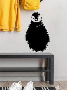 Close-up of minimalist black penguin PVC wall sticker on a white bedroom wall