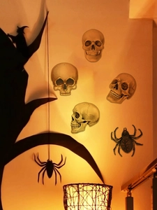 Detailed view of Halloween skeleton heads and black spider wall stickers for festive decor