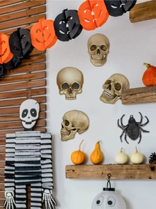 Detail view of five Halloween wall stickers featuring realistic skulls and a black spider decal