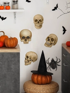 Detailed view of 3D Halloween skull stickers with bats and a spider on a kitchen wall