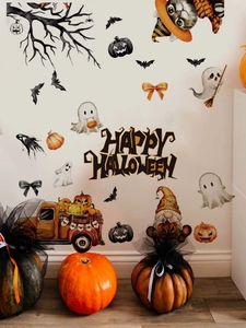 Detail of Halloween wall stickers featuring pumpkin truck, ghosts and bats on a white wall
