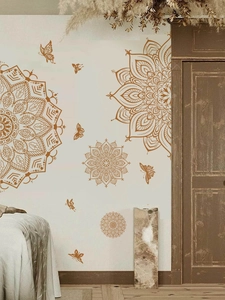 Close-up of golden mandala wall stickers with butterflies in a boho interior setting