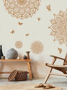 Detailed view of golden mandala wall stickers with butterfly accents in a boho living room