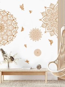 Detail of ochre mandala and butterfly wall stickers in a minimalist interior scene