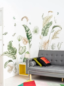 Detail of tropical banana leaf wall stickers in a modern living room setting