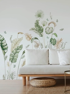 Detail of tropical banana leaf wall decals on a minimalist sofa background