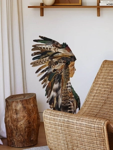 Detailed close-up of a colorful Indian feather girl wall decal in a cozy bohemian room