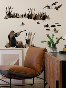 Detailed wall sticker showing hunter and ducks with realistic feather texture in living room