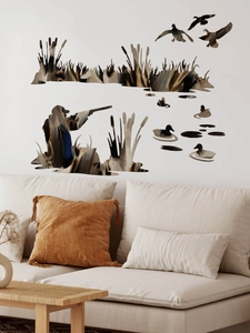 Detail view of wild duck hunting scene wall decals on a living room wall with a sofa