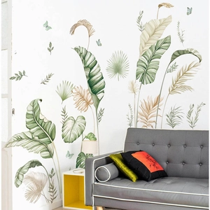 Tropical banana and palm leaf wall stickers with butterflies on a white living room wall