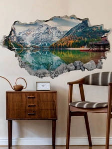 Detail of 3D broken wall decal showing snow mountains and lake in a living room