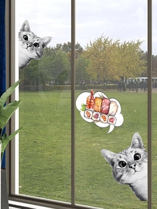 Detail showing two curious grey striped cats and sushi bubble wall stickers on a glass window