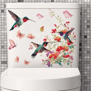 Vibrant floral toilet decal with hummingbirds and butterflies on a white ceramic tank