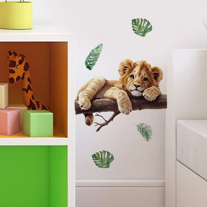 Cartoon lion cub on tree branch wall sticker with green leaves for nursery decoration
