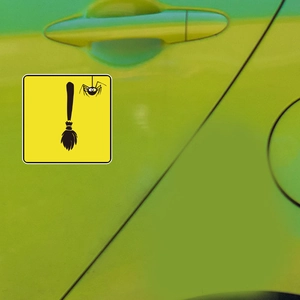 Halloween spider and broom car sticker on green vehicle door with yellow background