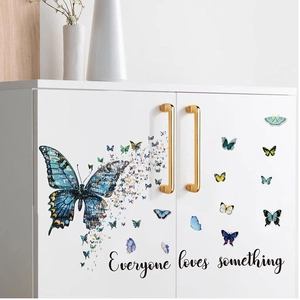 Blue butterfly wall stickers with artistic patterns and motivational quote on white cabinet