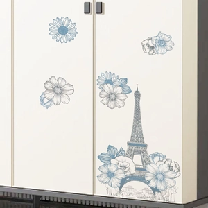 Blue Eiffel Tower and floral wall stickers applied on a cream-white storage cabinet