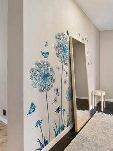 Detail view of blue gradient dandelion wall stickers with flying butterfly artwork