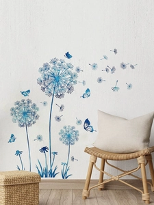 Detail view of blue dandelion wall stickers with flying butterflies on textured white wall