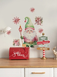 Detail van kerstkabouter muursticker met sneeuwvlokken en cadeaus op een witte muur
