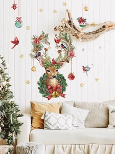 Close-up of watercolor reindeer wall sticker with festive ornaments and red birds