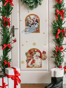 Detailed Christmas stickers featuring Santa and penguins on a white door with pine wreaths