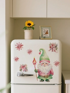 Details van de kerstkabouter en roze sneeuwvlok muurstickers op een witte koelkast