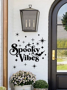Detail of Spooky Vibes Halloween wall sticker with bat and stars on a white brick wall