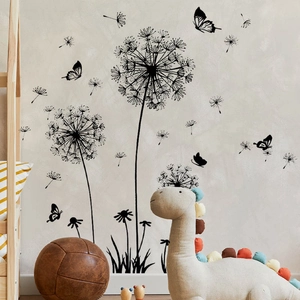 Black dandelion and butterfly wall stickers in a cozy nursery room with wooden bed