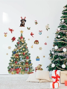 Detailed view of festive Christmas tree wall decals with gift boxes on white wall background
