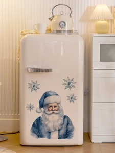 Detail of blue Santa Claus and watercolor snowflakes on a refrigerator surface