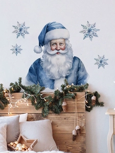 Blue watercolor Santa Claus wall decal set with snowflakes over a cozy bedroom headboard
