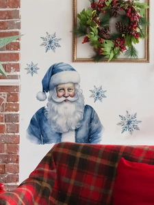 Detail of blue watercolor Santa Claus wall sticker with snowflakes on a cozy brick wall