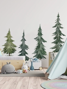 Nursery wall decor with watercolor pine trees decals on white wall in cozy kids bedroom