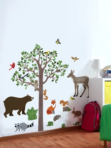 Detail of forest animal wall stickers with bear, deer and owl on white room corner