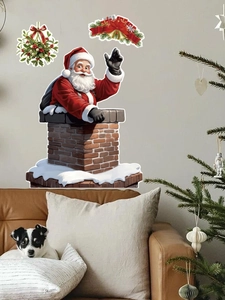 Detail of PVC Santa Claus wall sticker emerging from a chimney in a cozy room setting