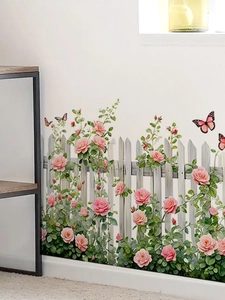 Detail of pink rose wall stickers with white fence and butterflies on a white wall