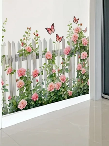 Macro detail of pink rose stickers and white picket fence decals on a white wall corner