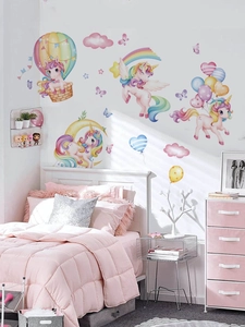 Detailed view of dreamy pink unicorn wall decals applied to a warm nursery bedroom wall