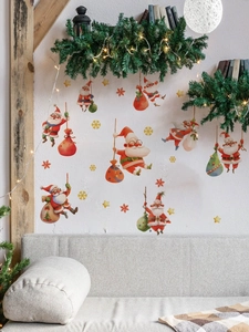 Détail de stickers muraux Père Noël avec flocons et étoiles dans un salon festif décoré