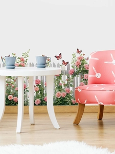 Detail of pink rose fence wall decals in a cozy room with white table and chair