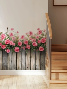 Détail de stickers muraux roses et clôture grise sur le mur blanc d'un escalier