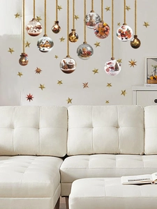 Detail of Christmas wall stickers featuring Santa, snowman, and gold stars on a white wall