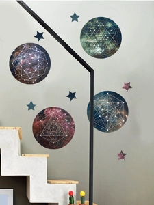 Detail view of cosmic galaxy wall stickers with sacred geometry on a modern grey wall