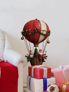 Detailed Santa Claus and snowman sitting in a festive hot air balloon ornament