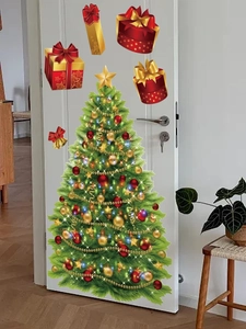 Detail of Christmas tree and gift box wall stickers on a white door for holiday home decor