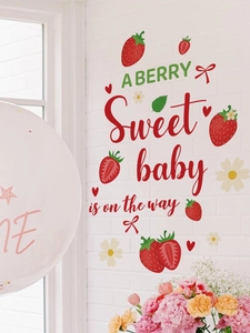 Detail showing Sweet Baby strawberry wall decals with daisies and bows on a white brick wall