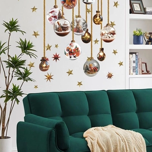 Christmas wall decal with Santa, reindeer and snowman baubles above a sofa