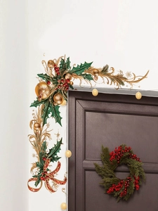 Detail of Christmas wall stickers with green holly leaves and red berries on a door frame